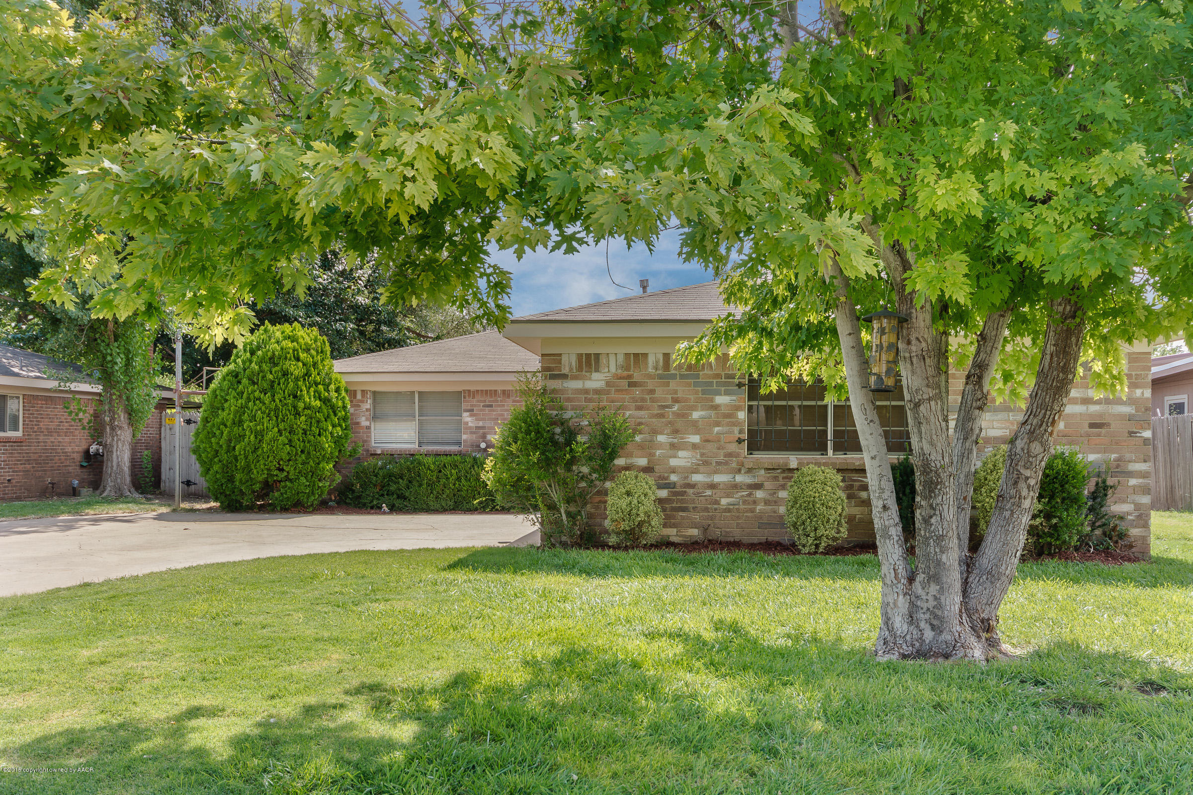 5017 Tulip Avenue Amarillo, TX 79110 - Photo 2 of 16 a front view of a house with a garden