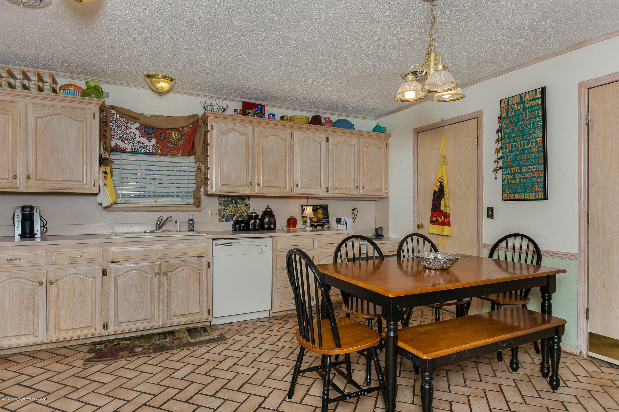 5017 Tulip Avenue Amarillo, TX 79110 - Photo 3 of 16 a kitchen with a dining table and chairs