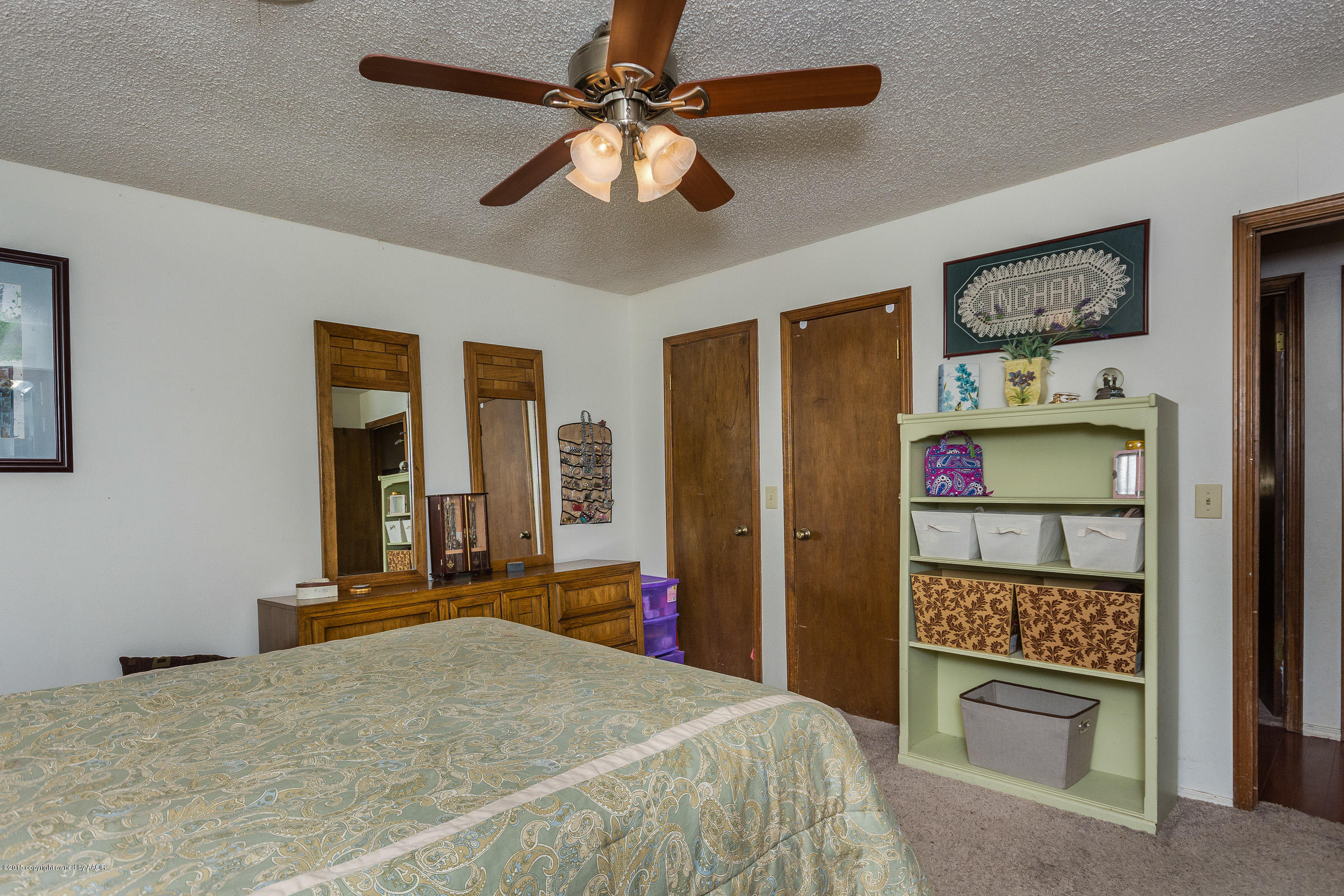 5017 Tulip Avenue Amarillo, TX 79110 - Photo 8 of 16 a bedroom with a bed and a chandelier