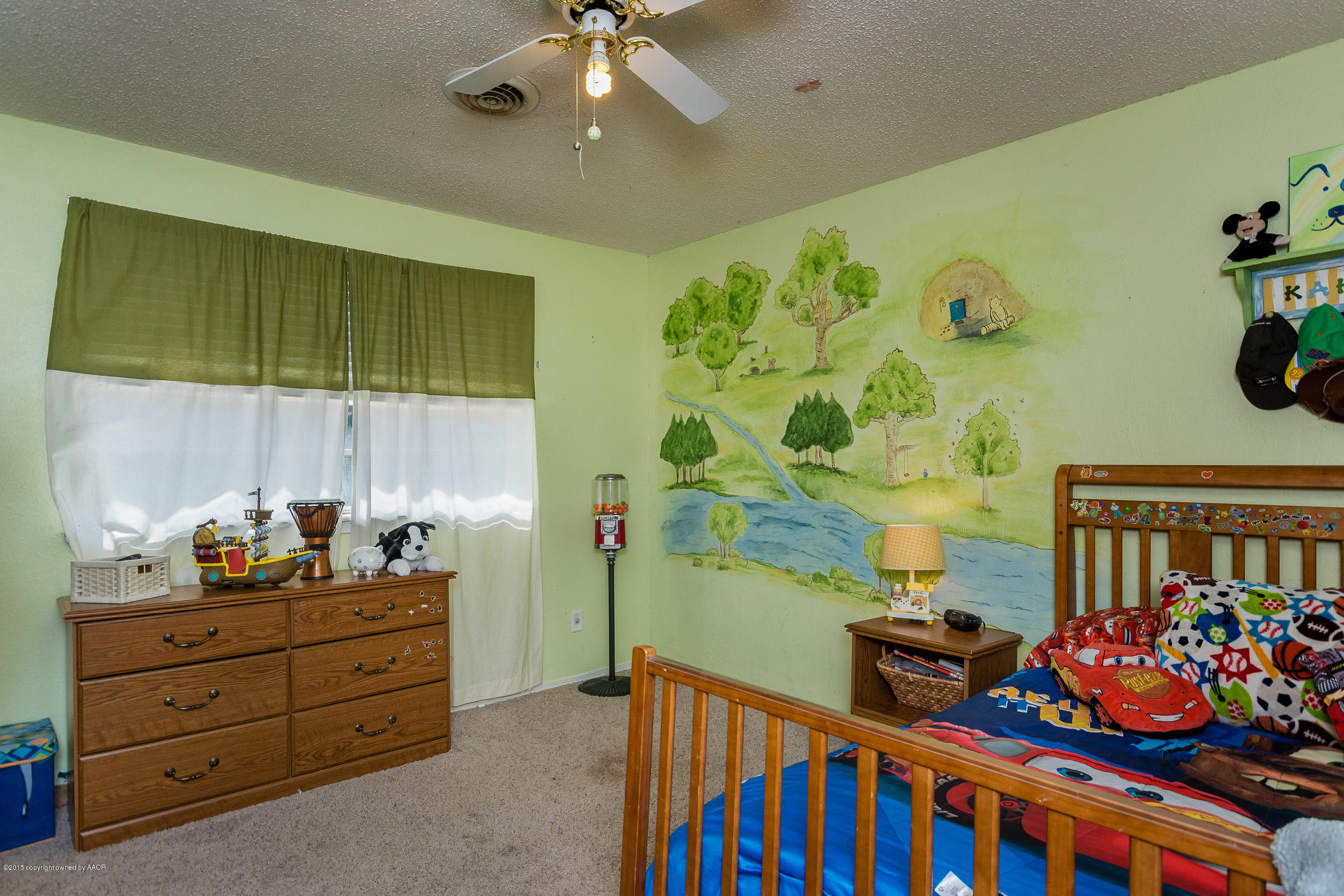 5017 Tulip Avenue Amarillo, TX 79110 - Photo 10 of 16 a bedroom with furniture and a baby crib