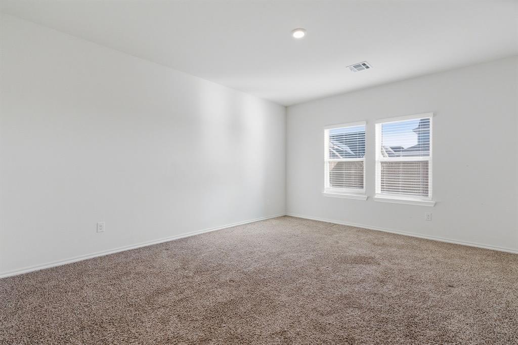 709 Primrose Lane Pilot Point, TX 76258 - Photo 12 of 35 Carpeted spare room with baseboards and recessed lighting