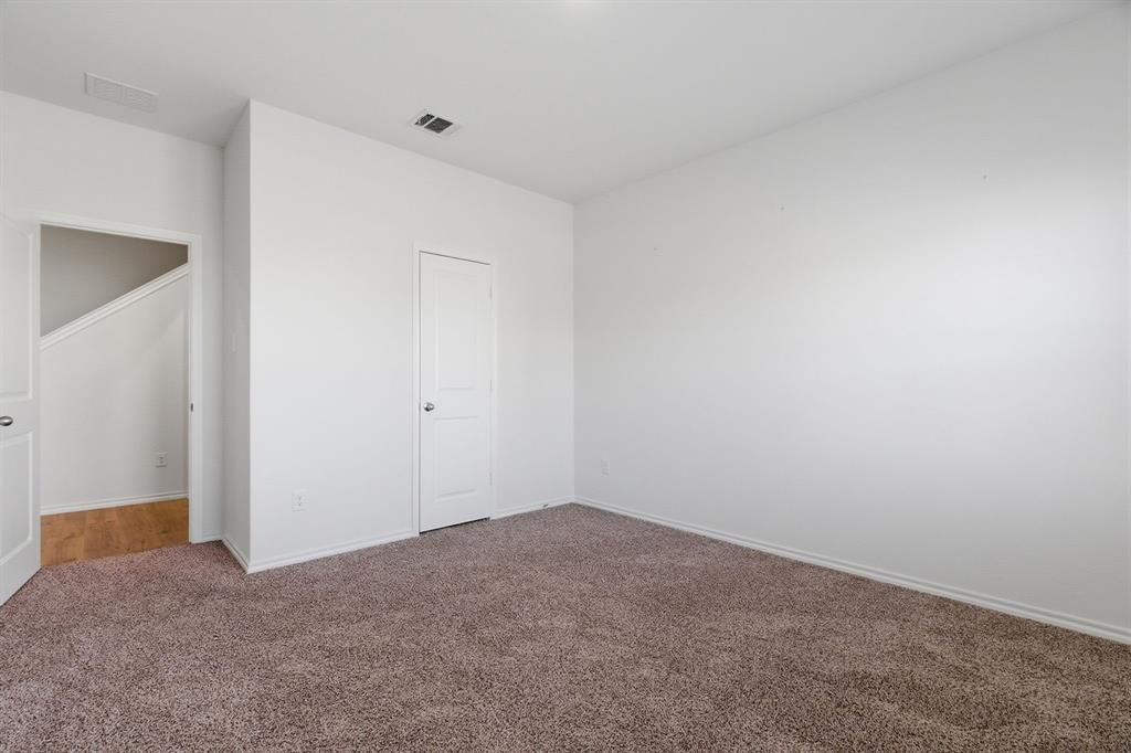 709 Primrose Lane Pilot Point, TX 76258 - Photo 13 of 35 Unfurnished bedroom with carpet flooring and baseboards