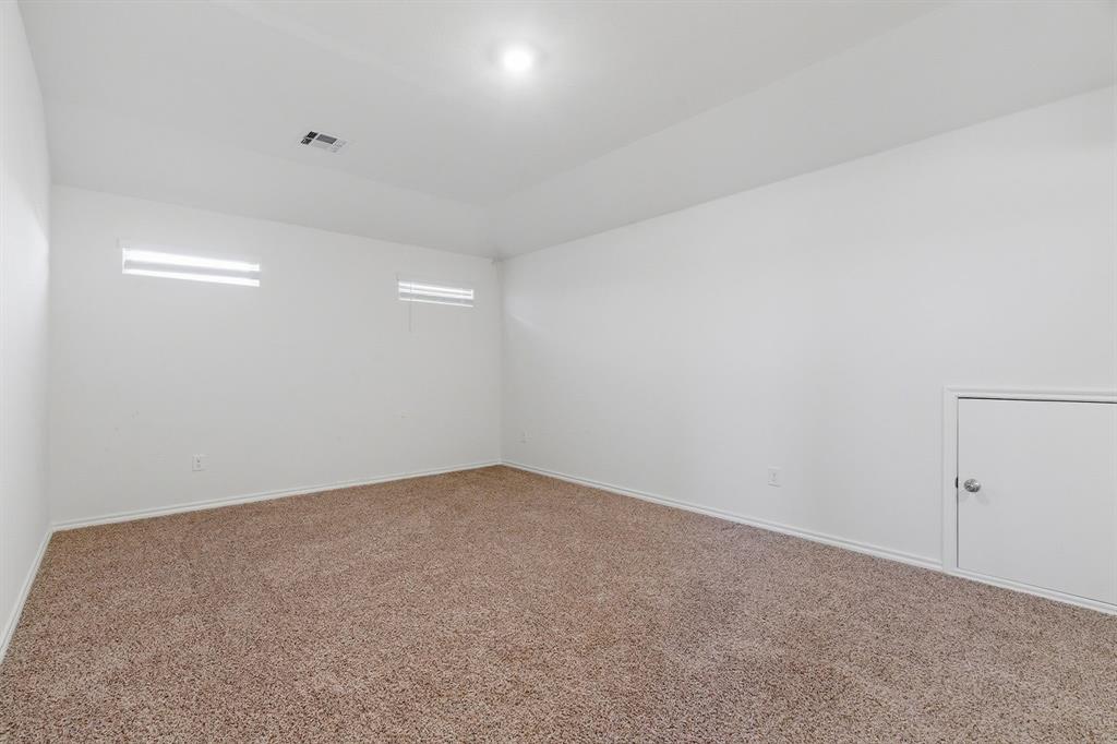 709 Primrose Lane Pilot Point, TX 76258 - Photo 15 of 35 Carpeted spare room featuring baseboards