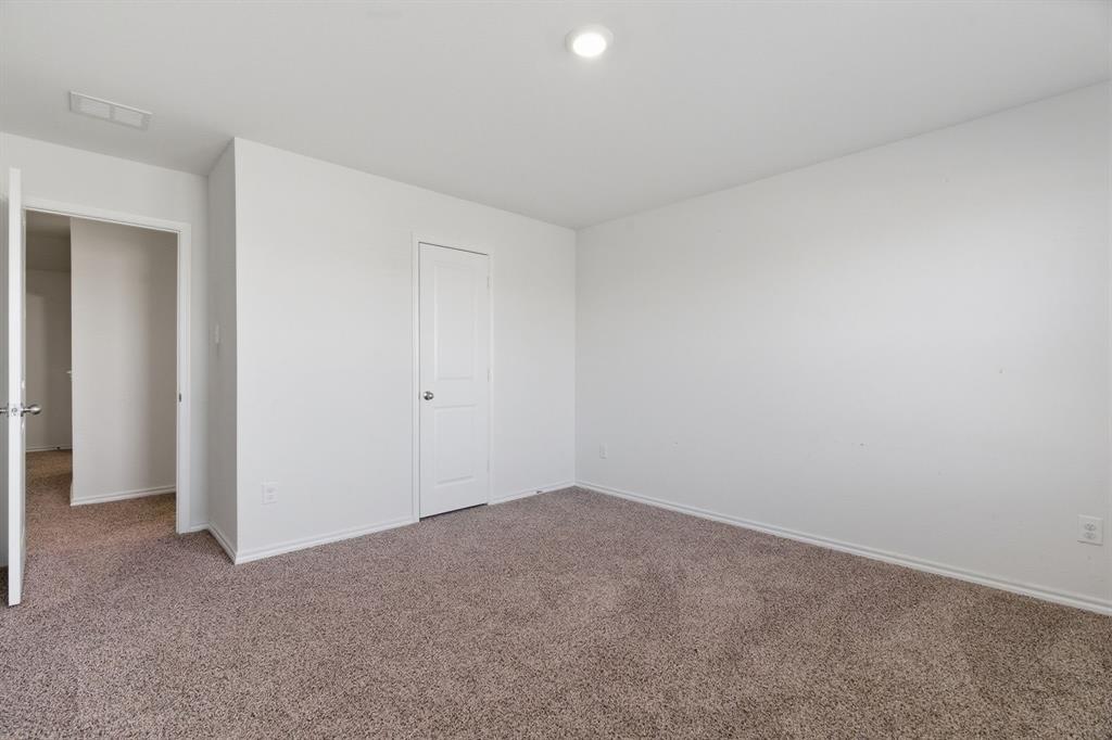 709 Primrose Lane Pilot Point, TX 76258 - Photo 16 of 35 Unfurnished bedroom with carpet floors and baseboards