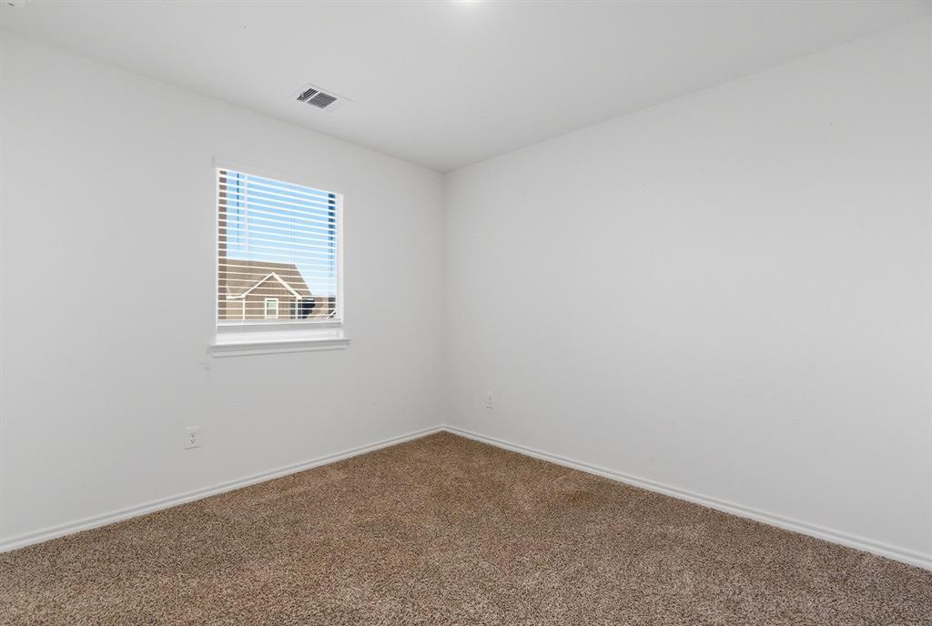 709 Primrose Lane Pilot Point, TX 76258 - Photo 18 of 35 Carpeted spare room with baseboards