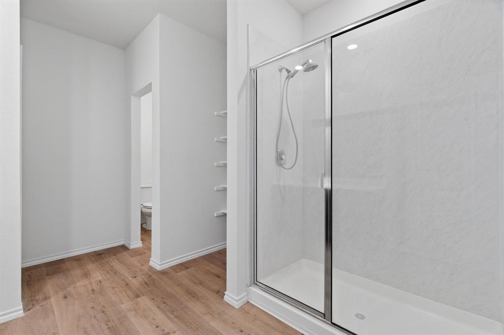 709 Primrose Lane Pilot Point, TX 76258 - Photo 21 of 35 Full bathroom with a stall shower and light wood finished floors