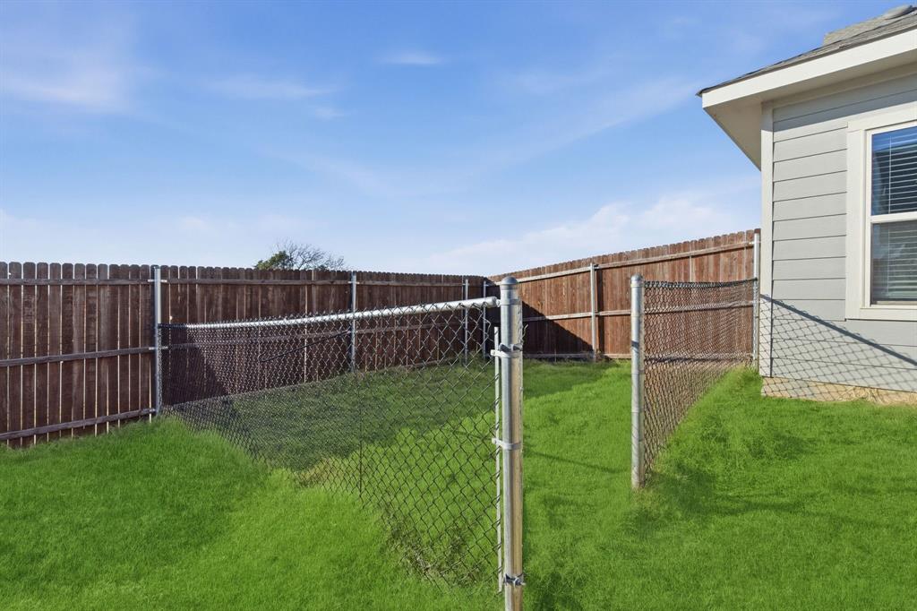 709 Primrose Lane Pilot Point, TX 76258 - Photo 29 of 35 Fenced backyard featuring a gate