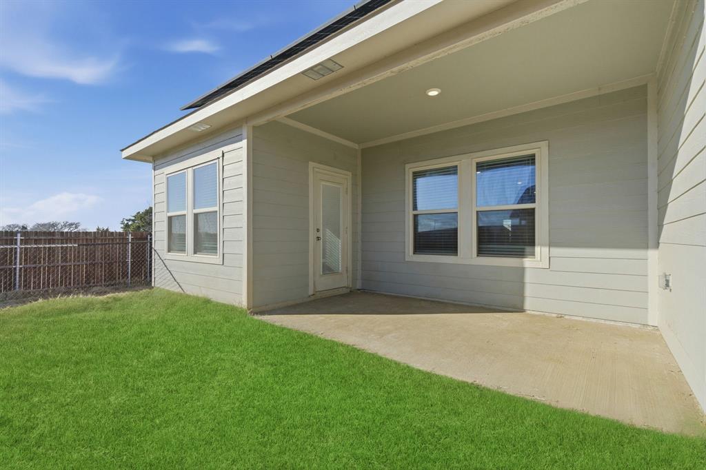 709 Primrose Lane Pilot Point, TX 76258 - Photo 30 of 35 View of exterior entry with a patio area