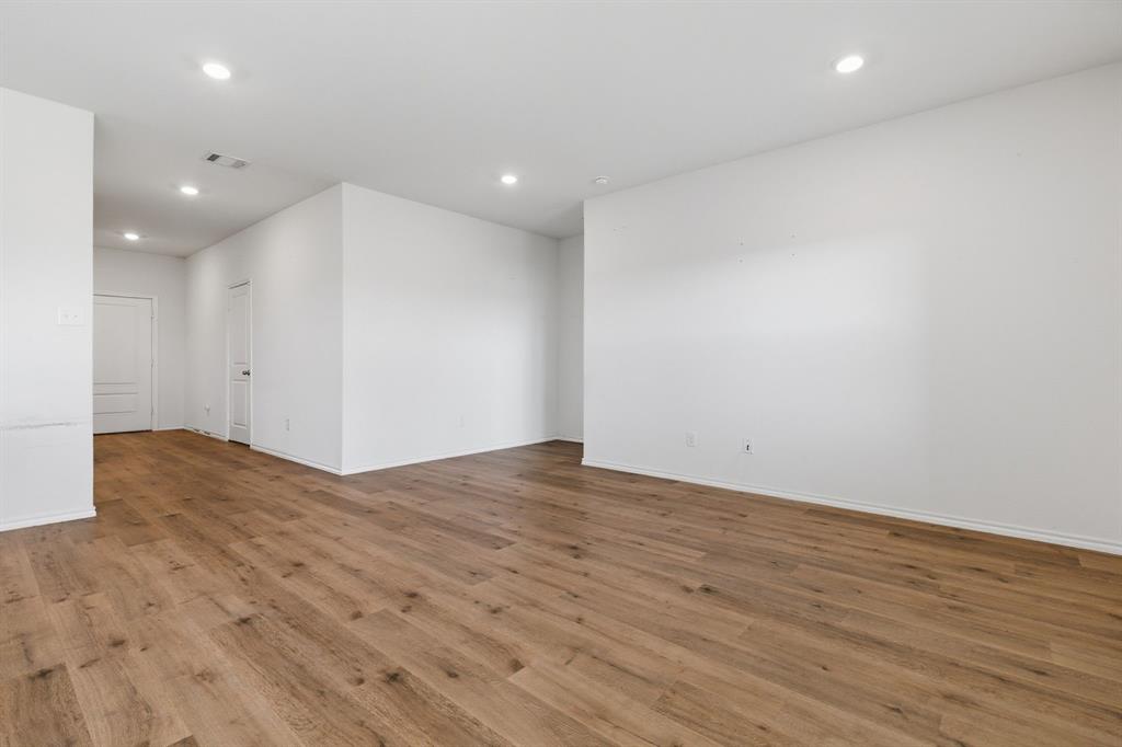709 Primrose Lane Pilot Point, TX 76258 - Photo 5 of 35 Empty room featuring recessed lighting and wood finished floors