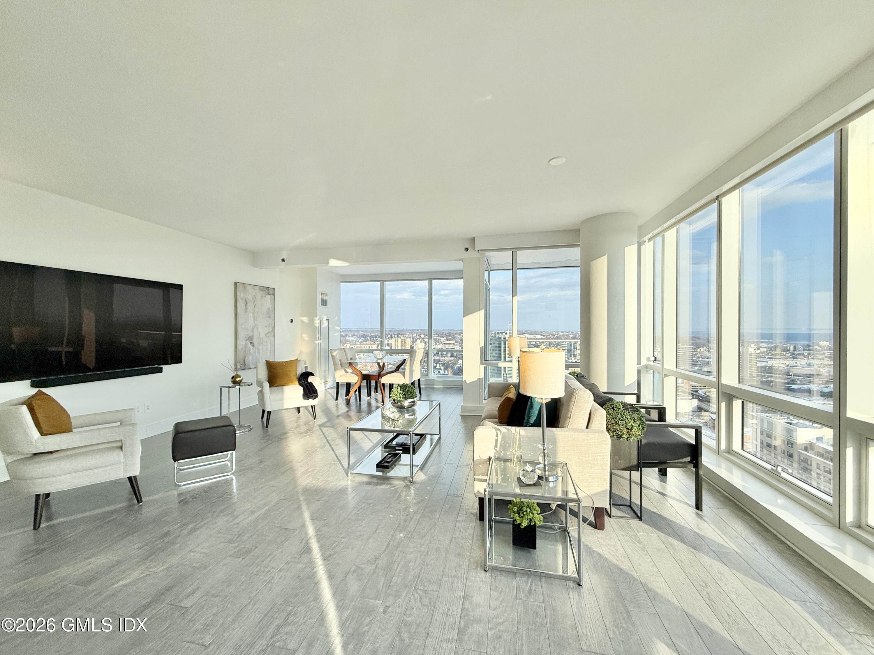 1 Broad Street, Unit PH31F Stamford, CT 06901 - Photo 2 of 13 a living room with furniture and a flat screen tv