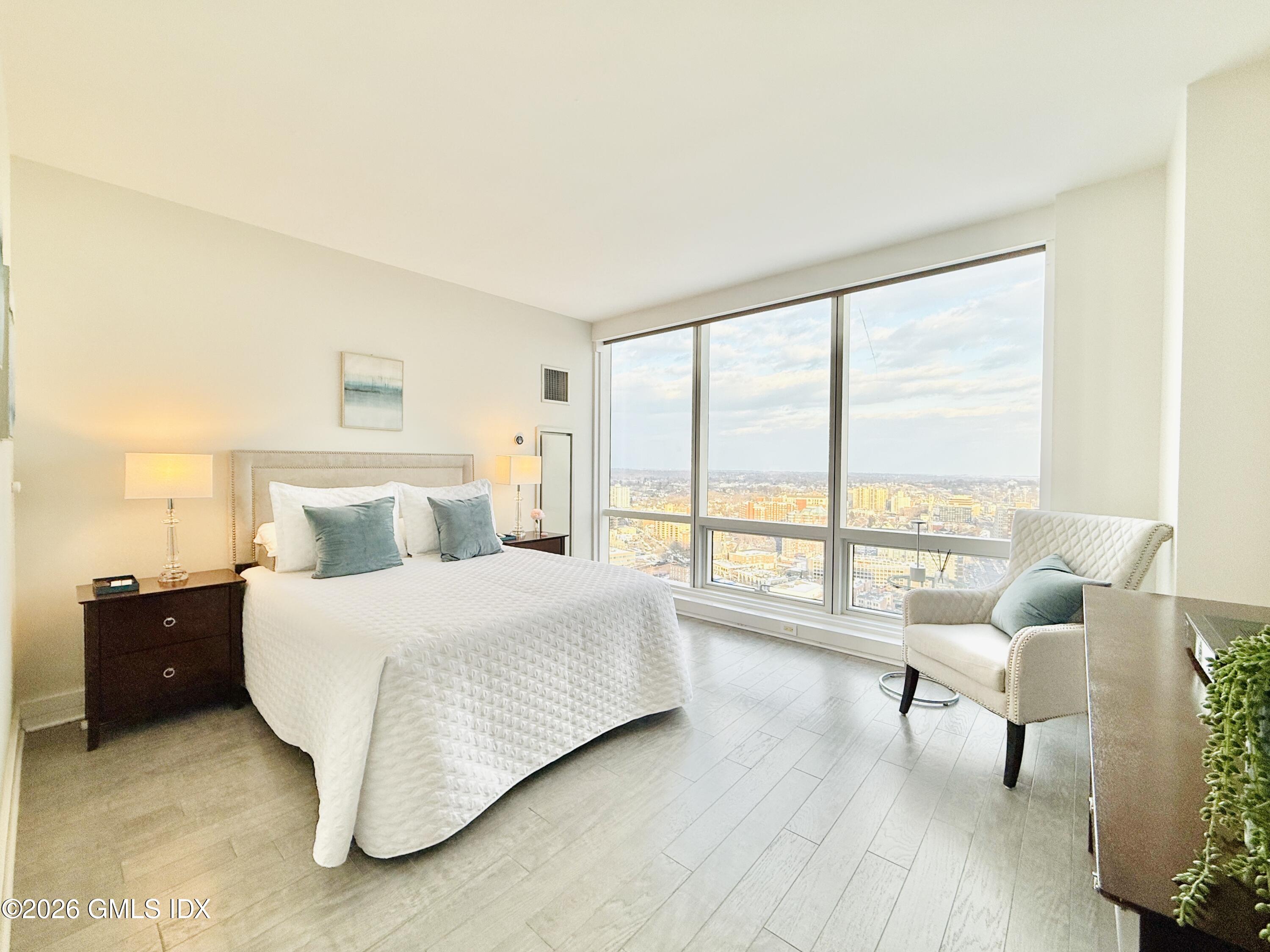 1 Broad Street, Unit PH31F Stamford, CT 06901 - Photo 7 of 13 a bedroom with a bed and a large window