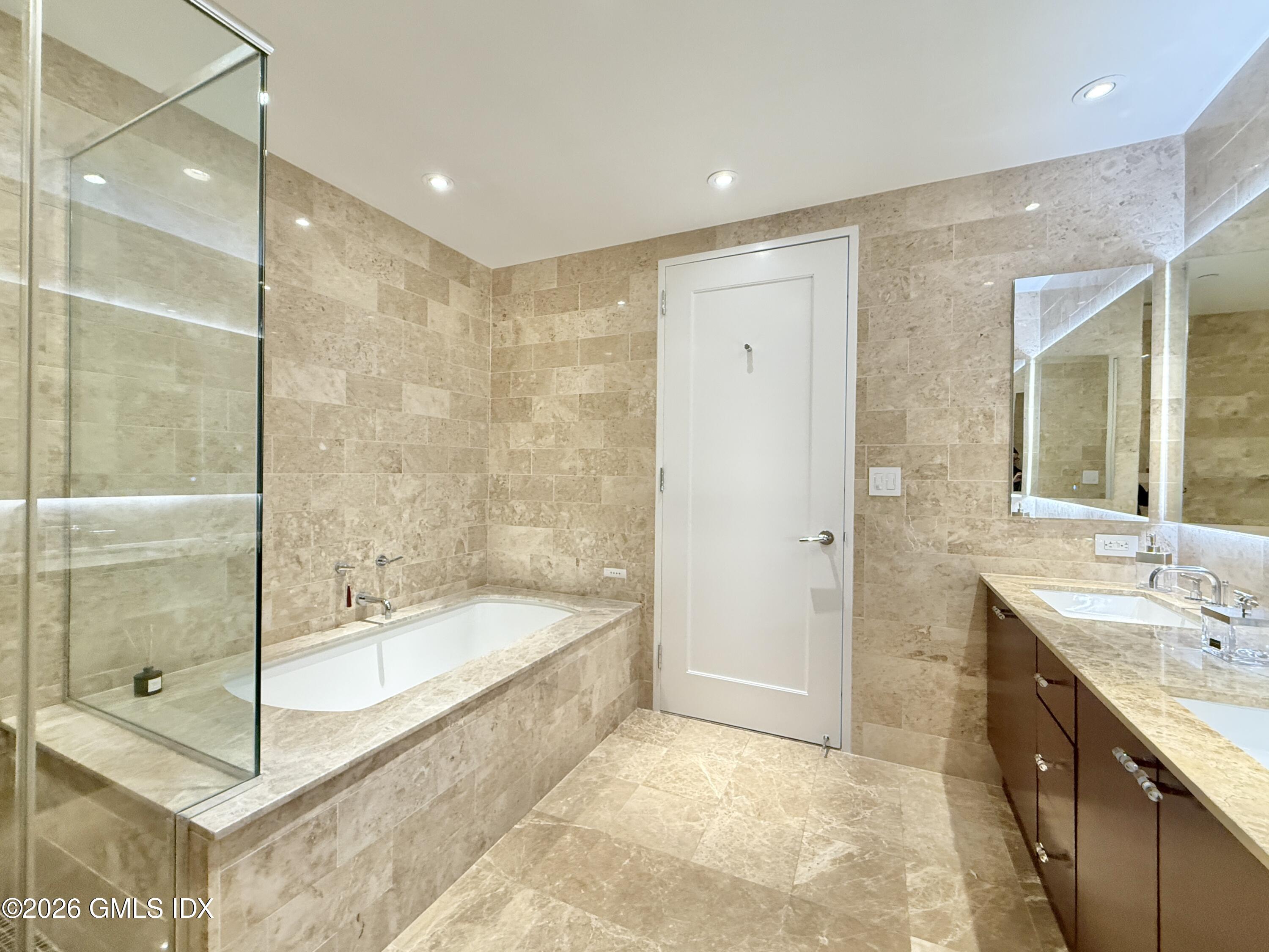 1 Broad Street, Unit PH31F Stamford, CT 06901 - Photo 8 of 13 a bathroom with a bathtub shower sink and mirror