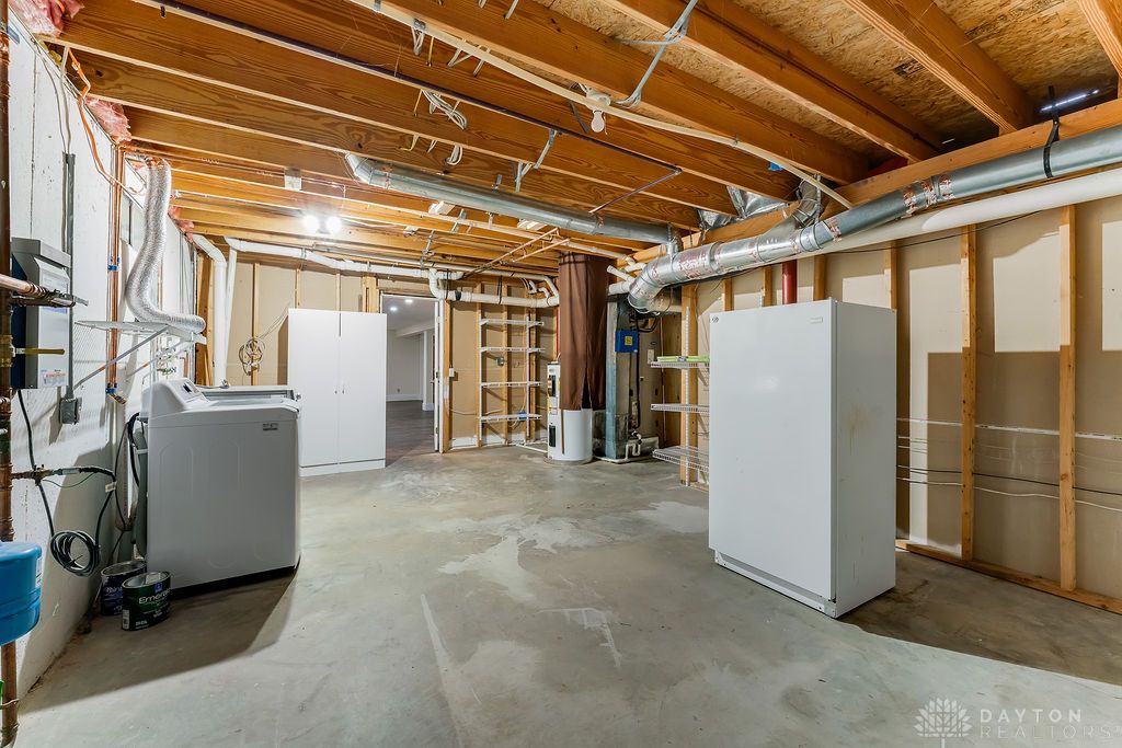7400 Cook-Jones Road Waynesville, OH 45068 - Photo 52 of 72 This spacious basement offers an unfinished layout with exposed wooden beams.