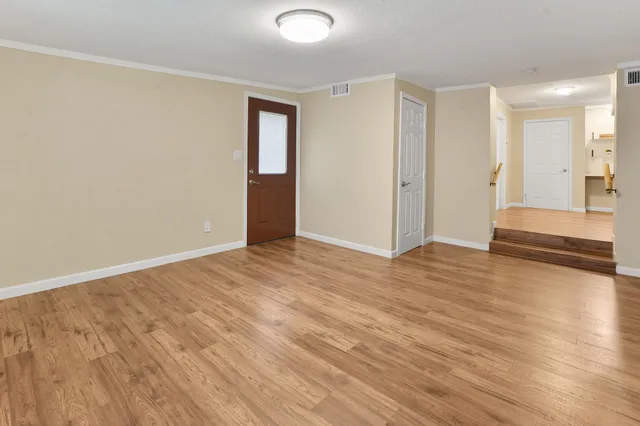 a view of an empty room and wooden floor