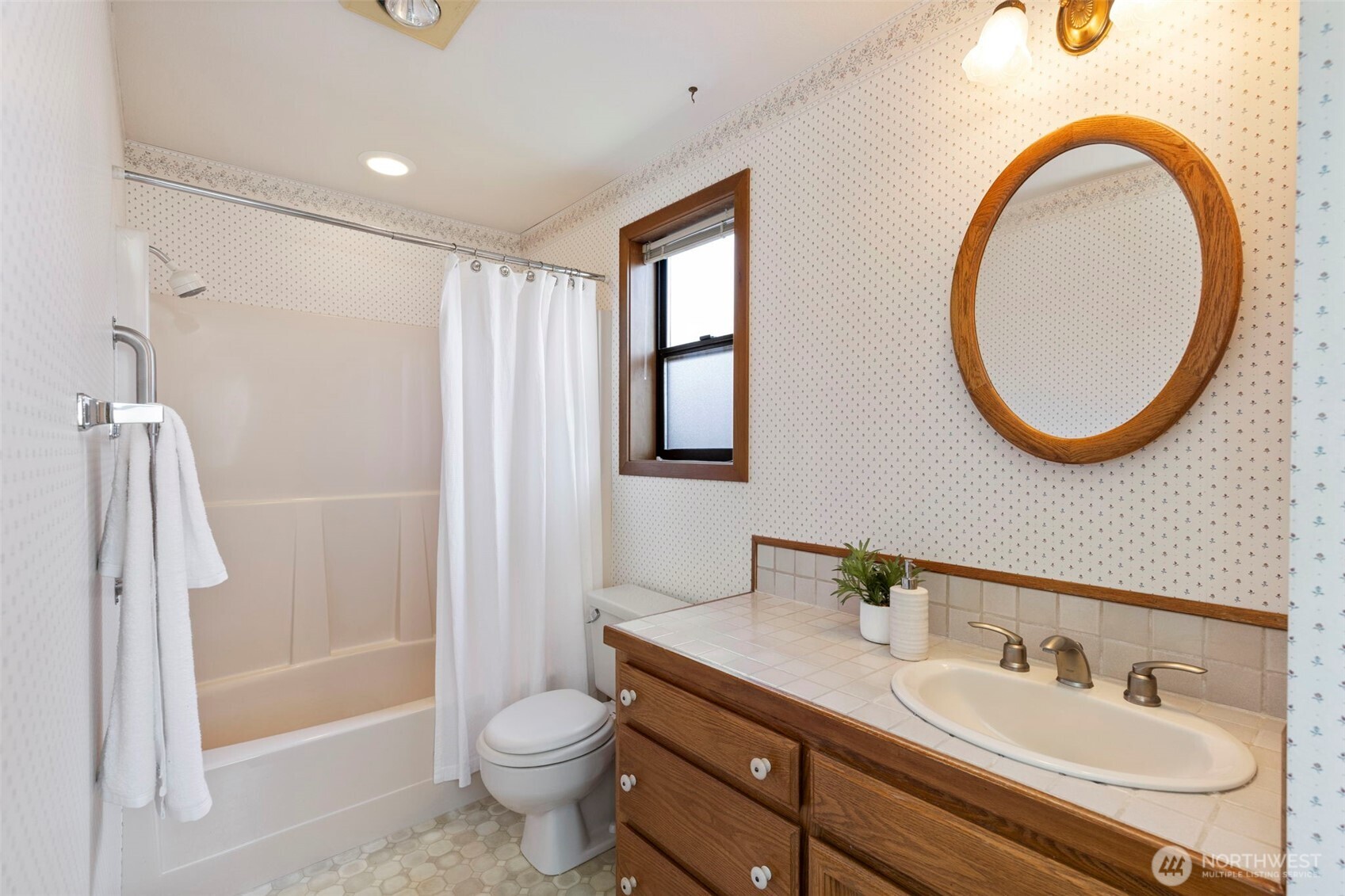909 55th Street Port Townsend, WA 98368 - Photo 14 of 36 a bathroom with a granite countertop toilet sink and a mirror