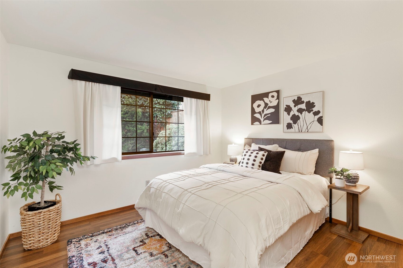 909 55th Street Port Townsend, WA 98368 - Photo 15 of 36 a bedroom with a large bed and a potted plant