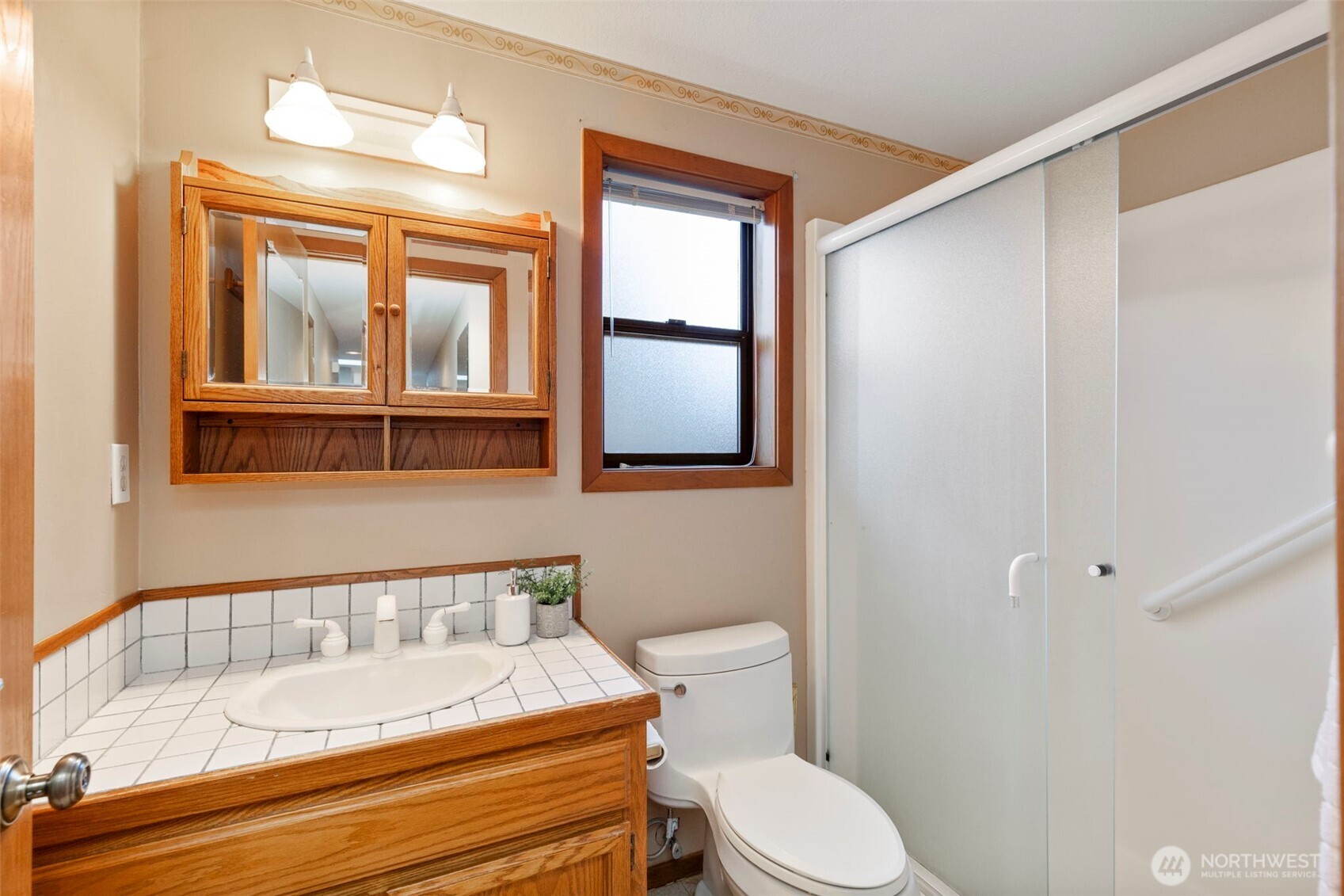 909 55th Street Port Townsend, WA 98368 - Photo 18 of 36 a bathroom with a granite countertop sink mirror vanity and toilet