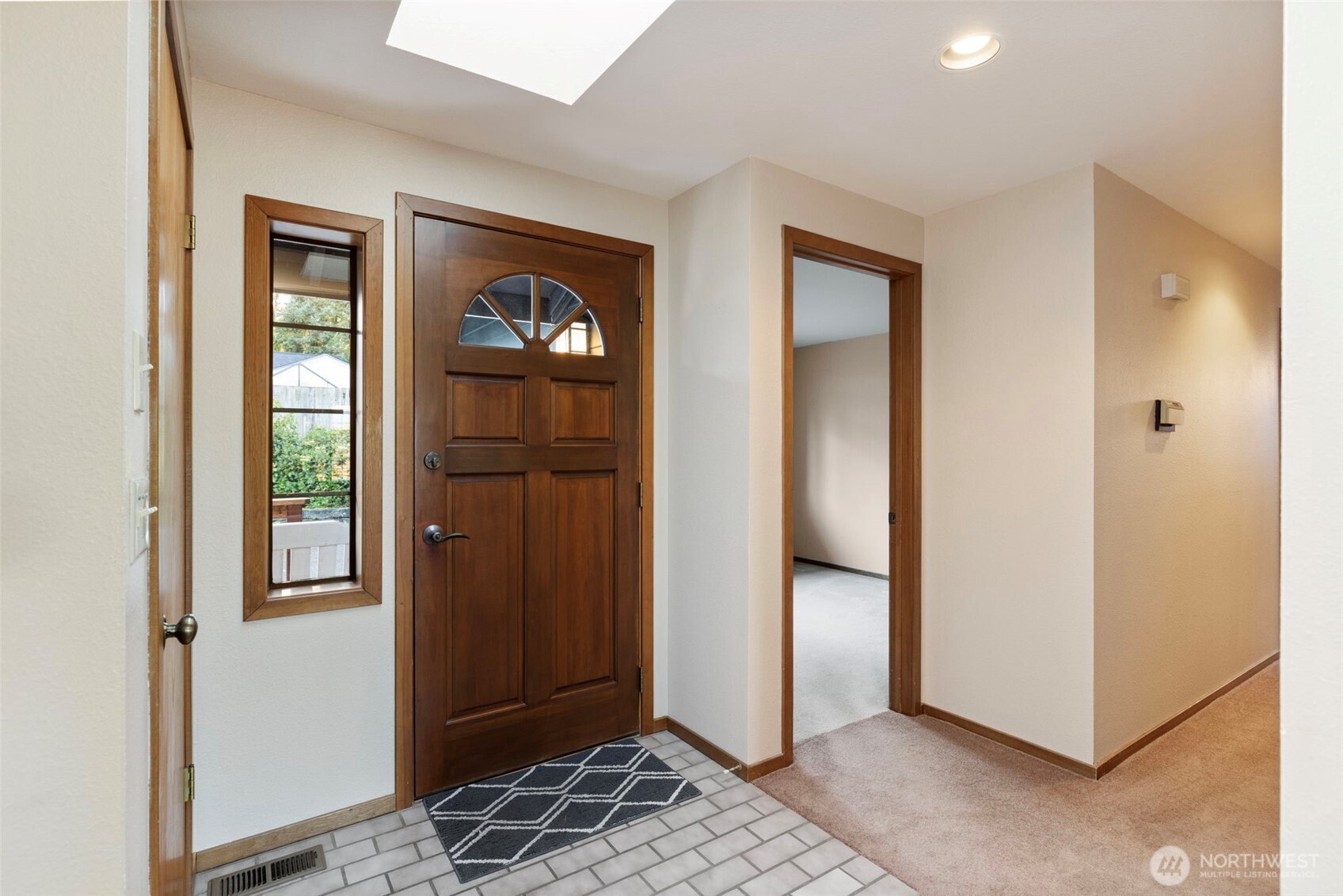 909 55th Street Port Townsend, WA 98368 - Photo 19 of 36 a view of a hallway with wooden floor and windows