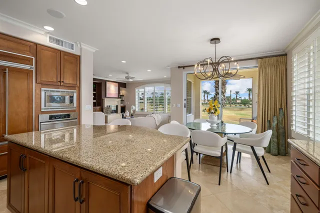 a kitchen with a sink a counter top space cabinets and stainless steel appliances