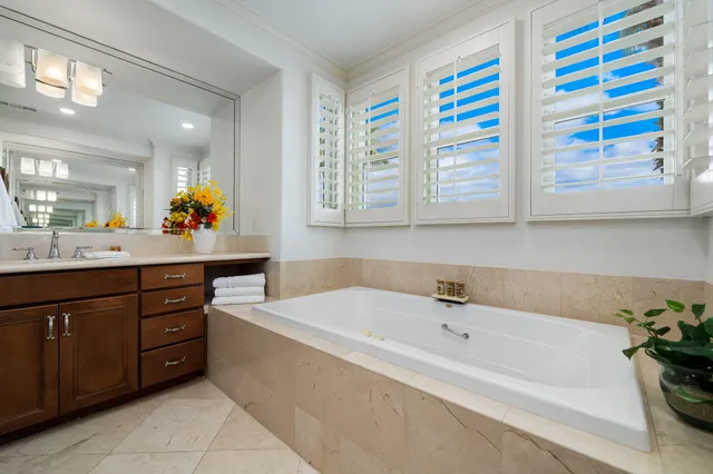 a bathroom with a sink mirror and vanity