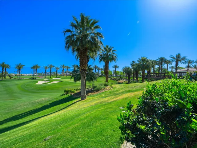 an aerial view of a golf course with parking space