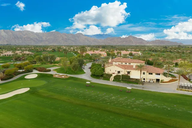 a view of a house with swimming pool and sitting area