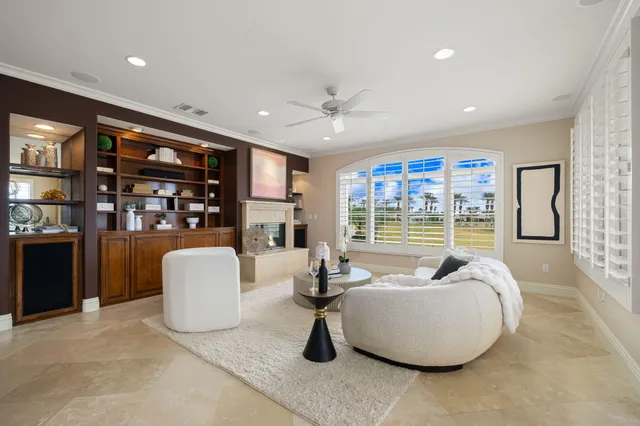 a dining room with furniture and a floor to ceiling window