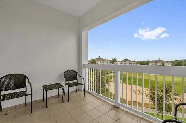a view of a balcony with chair and wooden floor