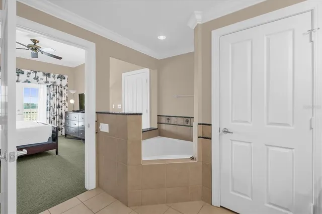 a bathroom with a tub shower and a sink