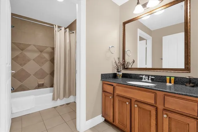 a bathroom with a double vanity sink mirror and shower