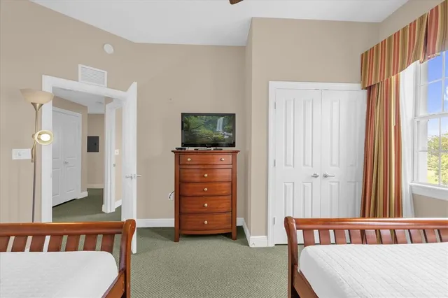 a bedroom with furniture and a window