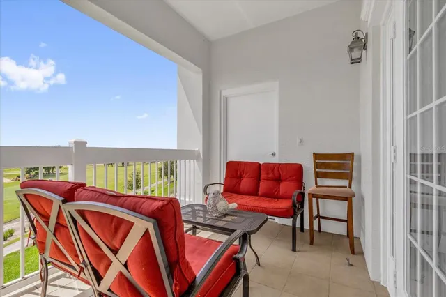 a living room with furniture a rug and a window