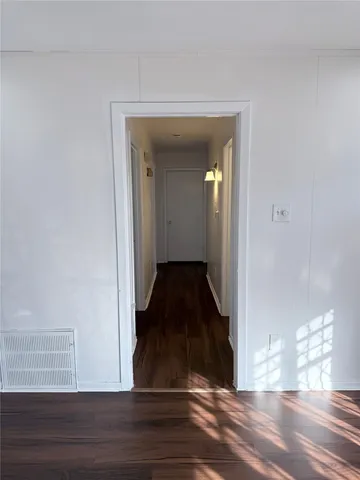 a view of a hallway view with wooden floor and staircase