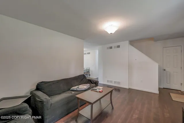 a view of a livingroom with furniture and a window