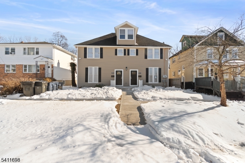 826 George Street, Unit 1 Plainfield, NJ 07062 - Photo 1 of 21 a view of a white house with a yard covered in snow