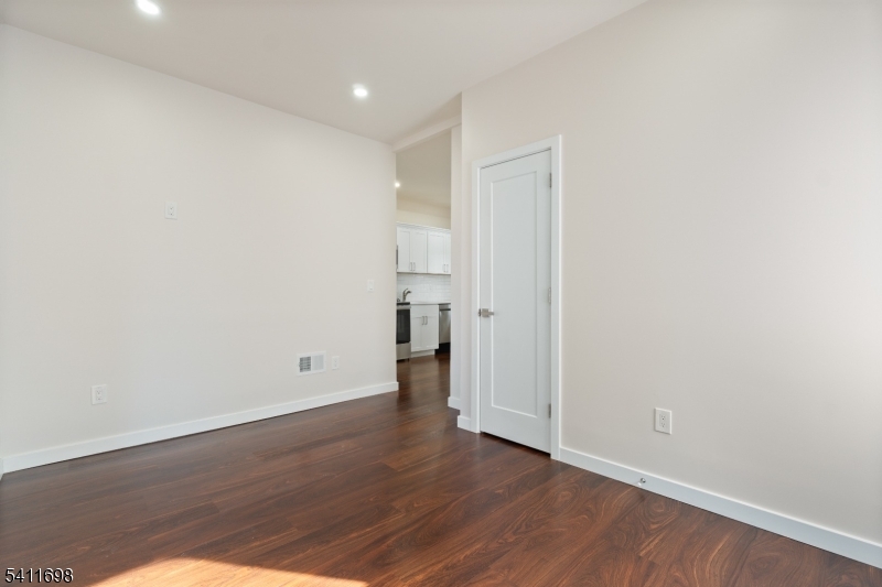 826 George Street, Unit 1 Plainfield, NJ 07062 - Photo 12 of 21 a view of an empty room with wooden floor and closet