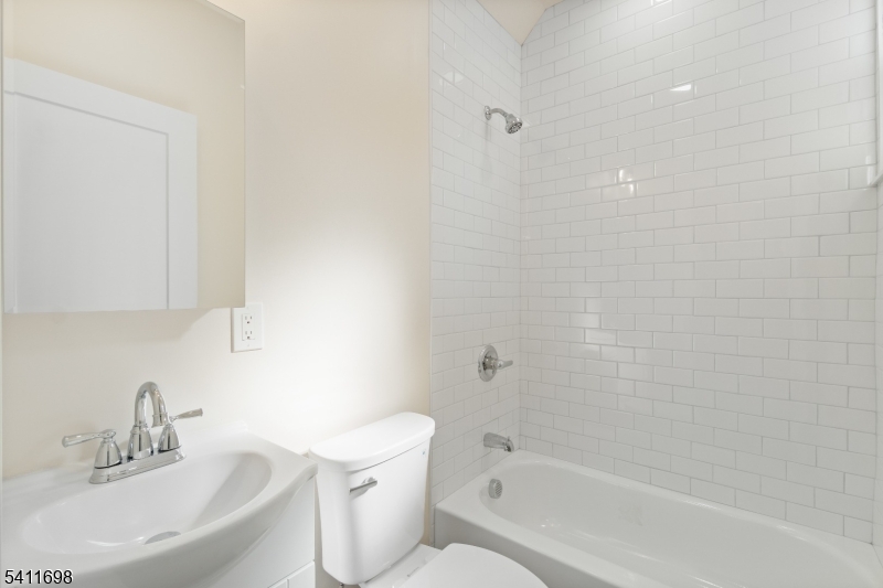 826 George Street, Unit 1 Plainfield, NJ 07062 - Photo 15 of 21 a bathroom with a bathtub shower sink vanity and toilet