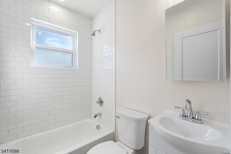 826 George Street, Unit 1 Plainfield, NJ 07062 - Photo 16 of 21 a white bath tub sitting next to a white sink