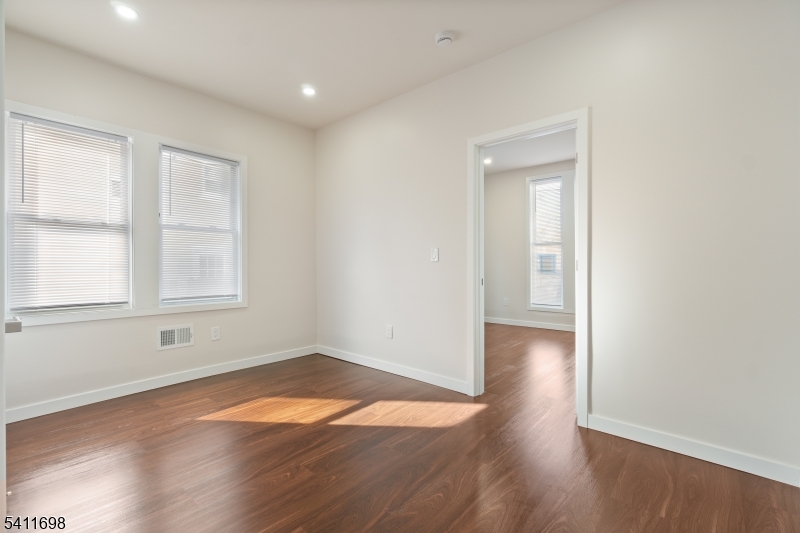 826 George Street, Unit 1 Plainfield, NJ 07062 - Photo 2 of 21 an empty room with wooden floor and windows