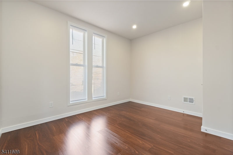 826 George Street, Unit 1 Plainfield, NJ 07062 - Photo 3 of 21 an empty room with wooden floor and window