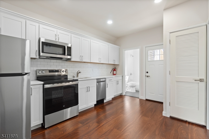 826 George Street, Unit 1 Plainfield, NJ 07062 - Photo 5 of 21 a kitchen with stainless steel appliances granite countertop a stove a sink and a microwave
