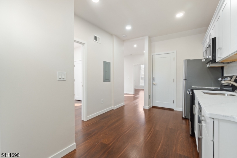 826 George Street, Unit 1 Plainfield, NJ 07062 - Photo 7 of 21 a view of a kitchen with a refrigerator and wooden floor