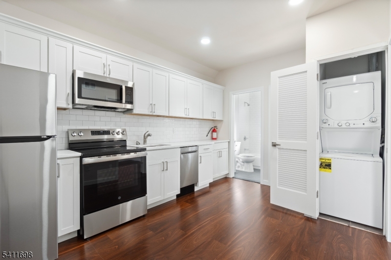 826 George Street, Unit 1 Plainfield, NJ 07062 - Photo 8 of 21 a kitchen with stainless steel appliances white cabinets and wooden floors