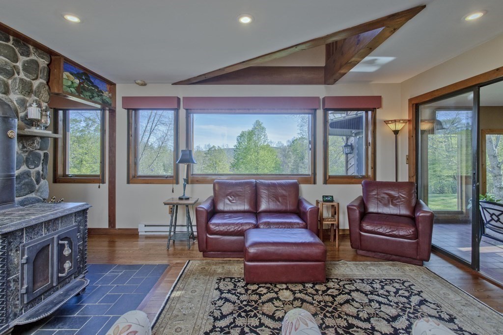 135 George Lamb Road Leyden, MA 01337 - Photo 17 of 42 a living room with furniture and a floor to ceiling window
