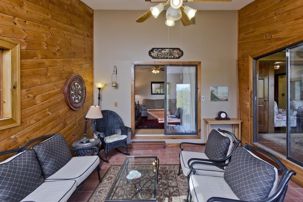 135 George Lamb Road Leyden, MA 01337 - Photo 23 of 42 a living room with furniture a clock on wall and a table