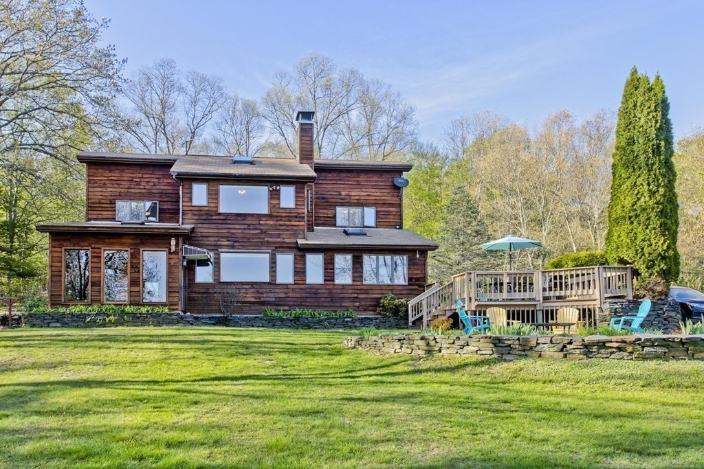 135 George Lamb Road Leyden, MA 01337 - Photo 39 of 42 a front view of a house with a garden and trees
