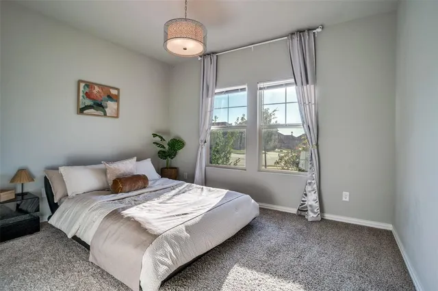 a bedroom with a large bed and a large window