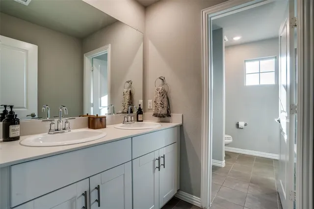 a bathroom with a double vanity sink and a mirror
