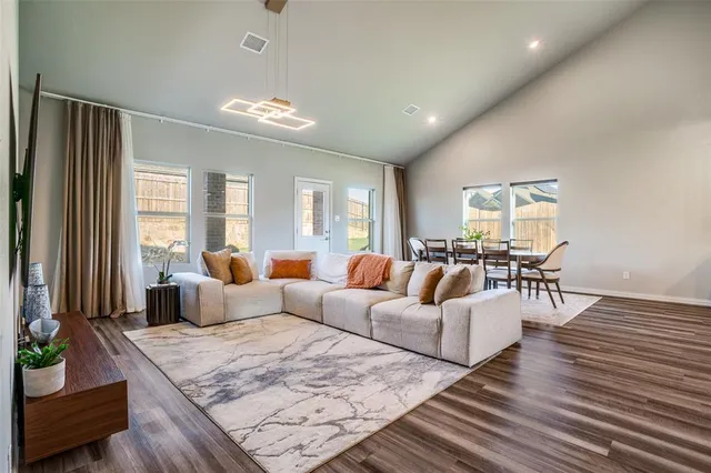 a living room with furniture and wooden floor