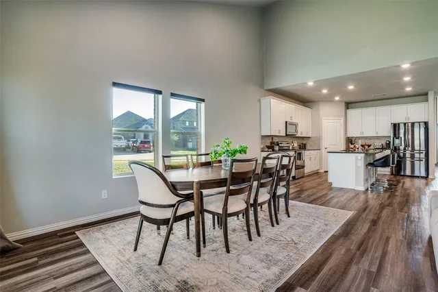 a dining room with furniture and wooden floor